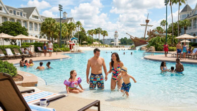 A happy family of Disney Resort Guests enjoys the massive pool at their hotel while checking in, visually emphasizing the complimentary water park access perk available on their first day