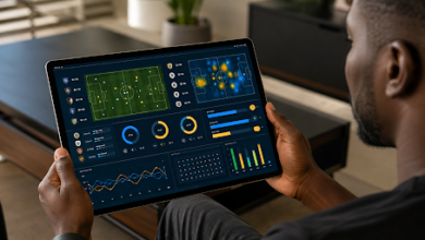 Man holds a tablet with sports analytics charts and match data